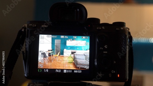 Obraz na płótnie Man photographer taking pictures indoor in living room - real estate home photography and professional video to sell the house apartment - interior design and home staging w salonie