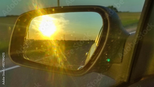 Obraz na płótnie Driving on the road in motion. View of a car mirror on Golden Sunset in Europe w salonie