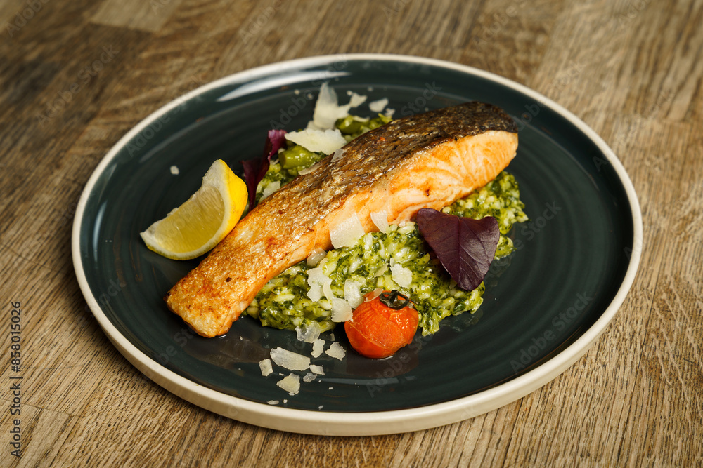Fried salmon with lemon, asparagus, broccoli, scallions