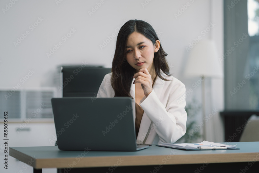 Business woman or financial data analysts working with smartphone and laptop computers and data graphs together. Plan to analyzing projects in the office. Business woman or financial data analysts working with smartphone and laptop computers and data graphs together. Plan to analyzing projects in the office.