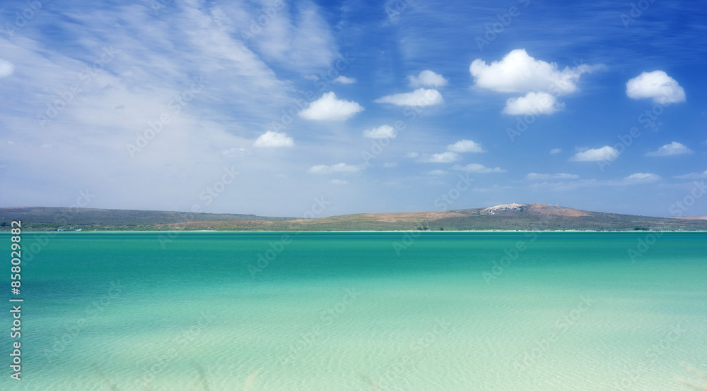 Blue sky, clouds and mountain with beach in nature for travel destination, vacation and calm water. Tropical island, coast and background of sea at sunset for holiday, peace and outdoor environment Blue sky, clouds and mountain with beach in nature for travel destination, vacation and calm water. Tropical island, coast and background of sea at sunset for holiday, peace and outdoor environment