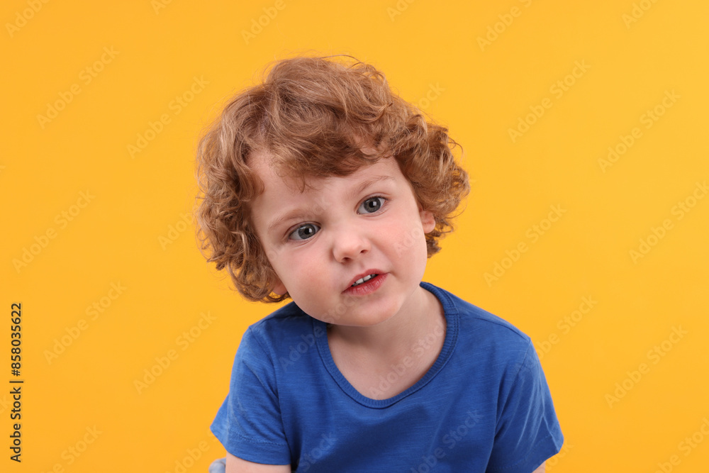 Portrait of cute little boy on yellow background Portrait of cute little boy on yellow background