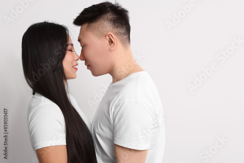 Portrait of happy couple on white background, space for text © New Africa