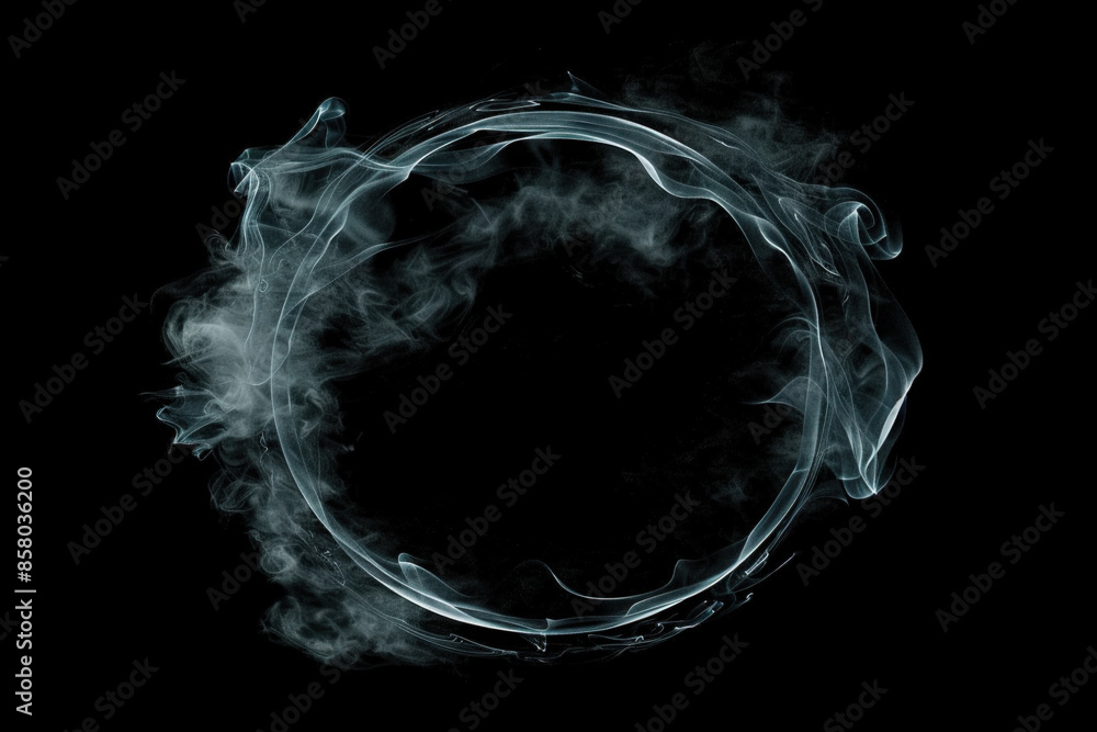 Naklejka premium Graceful swirling smoke forms a perfect circle on a black backdrop, creating a mesmerizing and mysterious pattern perfect for any design