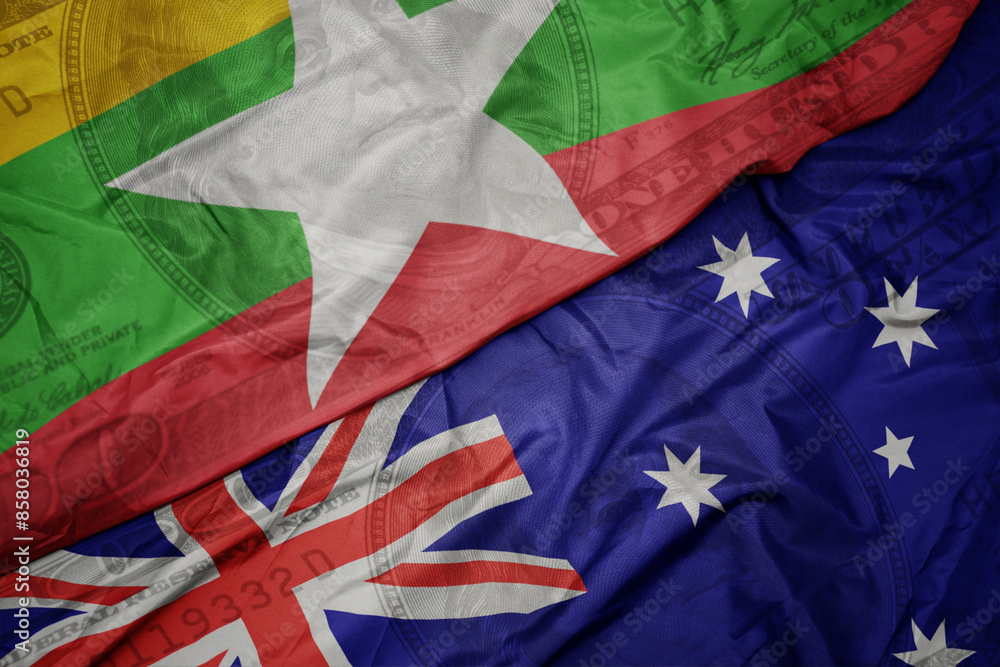waving colorful flag of myanmar and national flag of australia on the dollar money background. finance concept. waving colorful flag of myanmar and national flag of australia on the dollar money background. finance concept.