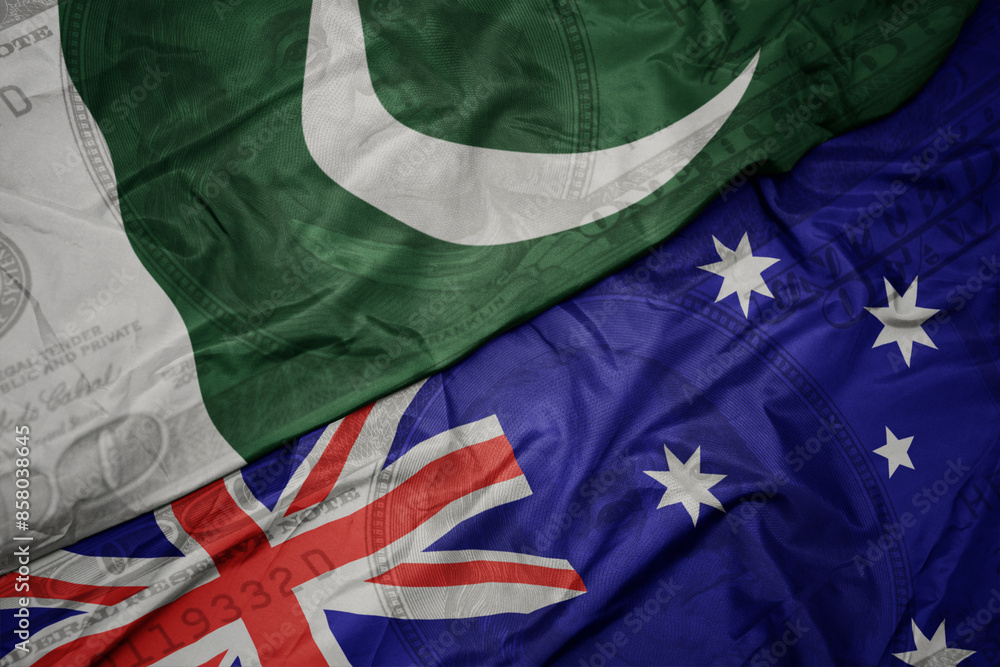 waving colorful flag of pakistan and national flag of australia on the dollar money background. finance concept. waving colorful flag of pakistan and national flag of australia on the dollar money background. finance concept.