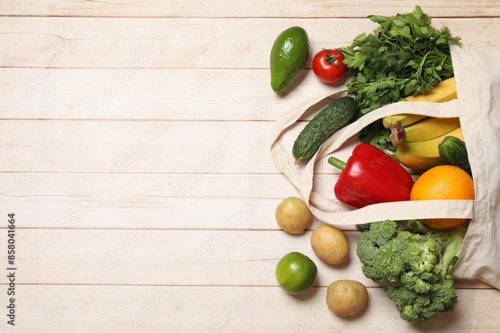 Vegan food delivery. Paper bag with different fresh vegetables and fruits on light wooden background, flat lay. Space for text Vegan food delivery. Paper bag with different fresh vegetables and fruits on light wooden background, flat lay. Space for text