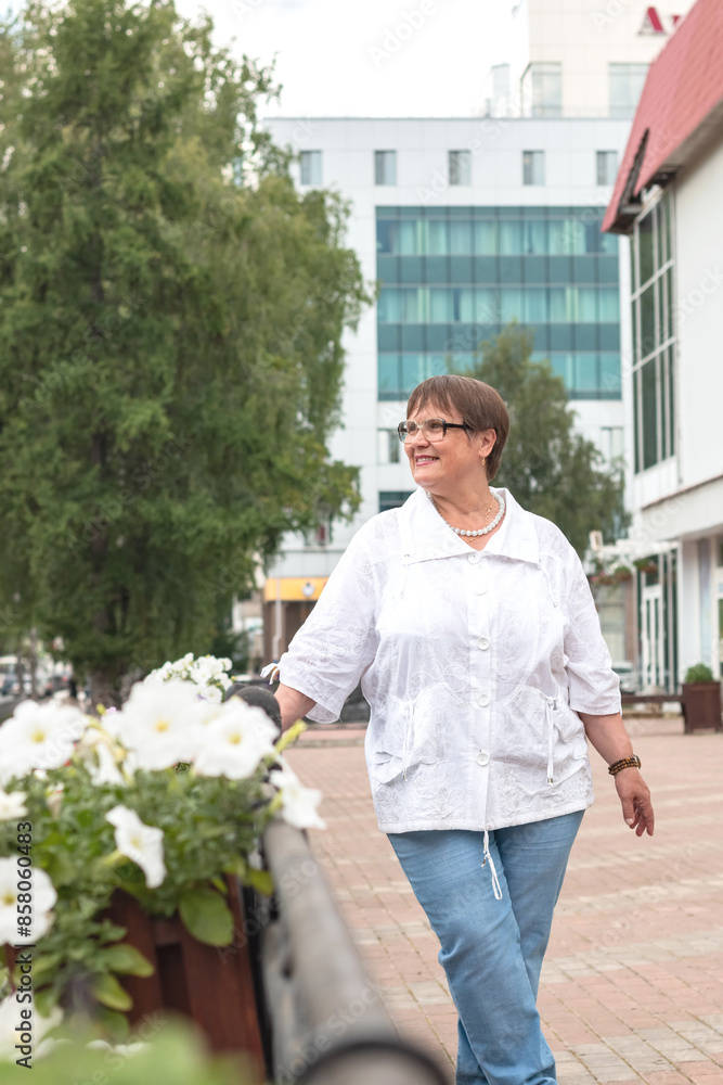 An elderly woman walks through the streets of the city. An elderly woman walks through the streets of the city.