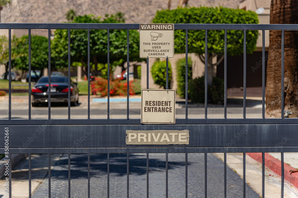 Gate at entrance to gated residential community Gate at entrance to gated residential community