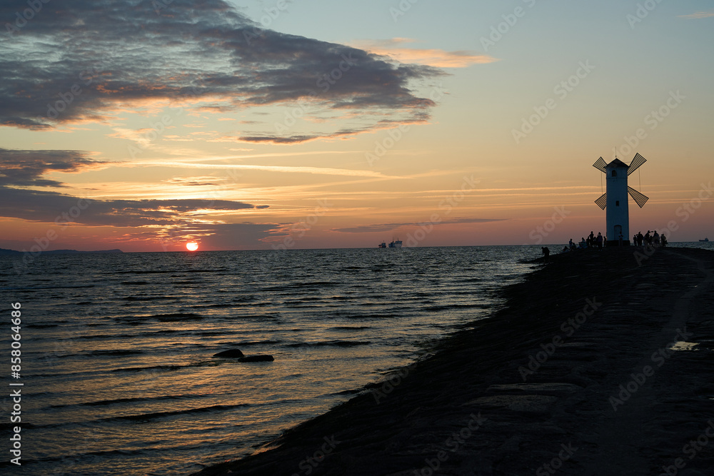 old fashioned windmill on the pier the coastline of usedom. old fashioned windmill on the pier the coastline of usedom.