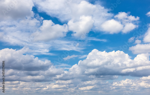 A bright summer sky with cumulus clouds as a background or texture