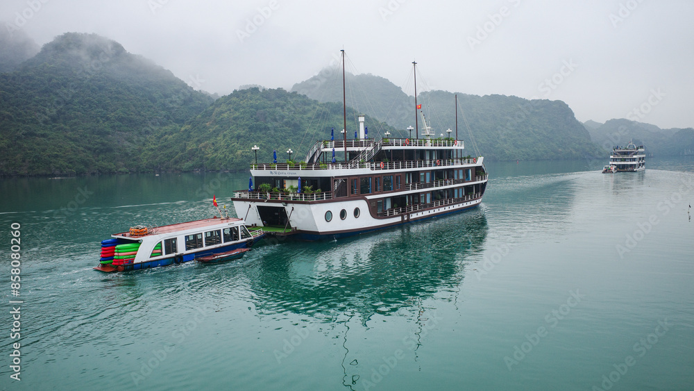 Halong Bay, Vietnam - 30 Jan, 2024: Cruise boats sailing on Ha Long Bay, a UNESCO World Heritage site in the South China Sea Halong Bay, Vietnam - 30 Jan, 2024: Cruise boats sailing on Ha Long Bay, a UNESCO World Heritage site in the South China Sea