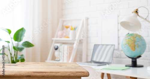 Fotografie Vintage wooden desk table top for product display in defocused education room