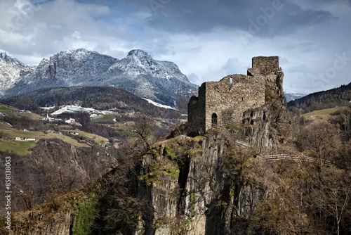 Collepietra: the medieval ruins of Steinegg castle and in the background the Catinaccio dolomite range. South Tyrol, Italy.
