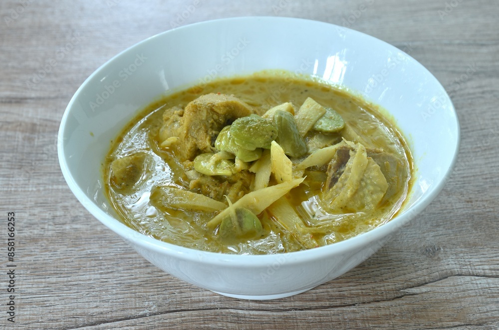 spicy boiled slice fresh bamboo shoot with chicken topping stink bean in coconut milk curry soup on bowl spicy boiled slice fresh bamboo shoot with chicken topping stink bean in coconut milk curry soup on bowl