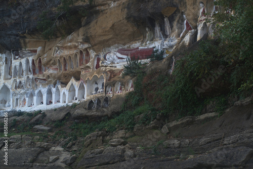 Akauk Taung has Buddha statues carved in sandstone in various forms such as sitting , standing and reclining on the cliff of Mount Akauk along the Ayeyavadee River near Htonbo Village, Magway, Myanmar photo