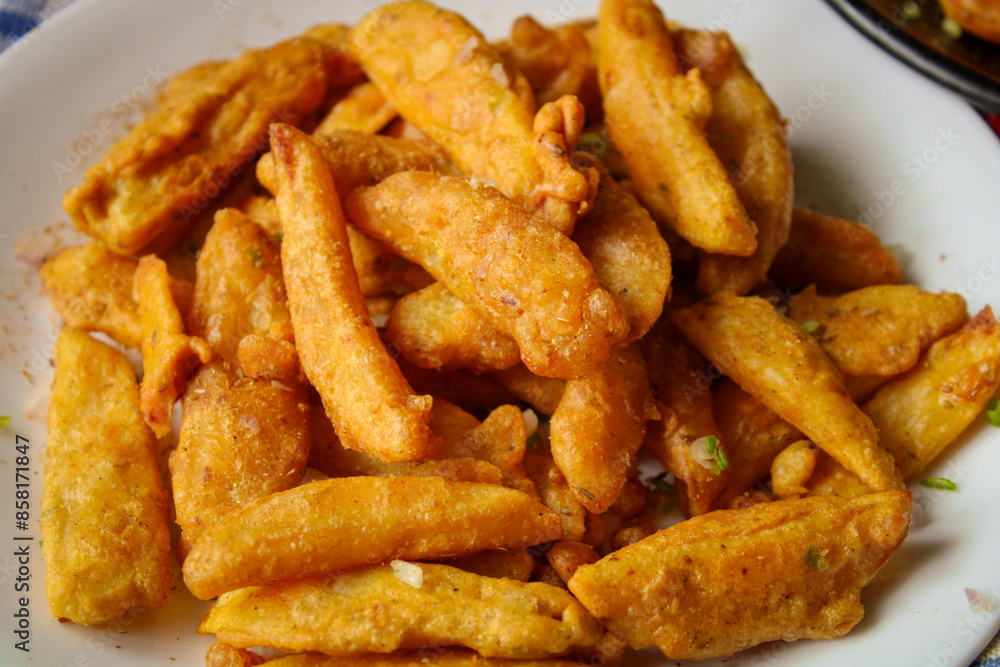 Aloo (Potato) Pakora - Indian style deep fried potato strip in batter garnished with fresh coriander and Indian spices Aloo (Potato) Pakora - Indian style deep fried potato strip in batter garnished with fresh coriander and Indian spices