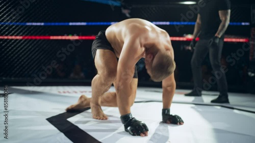 Professional Fighter Standing Up After a Successful Knockout by His Opponent. Portrait of a Fighter, Full of Adrenaline, Who Doesn't Retire, Still Hoping to Win the Championship photo