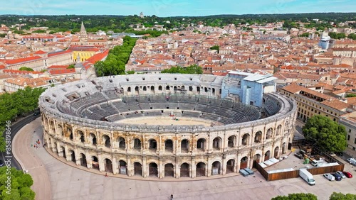 Aerial view of Imposing Roman amphitheatre hosting historic reconstructions in Nimes, France. View from above Amphitheatre of Nîmes and Museum Romanité in France.