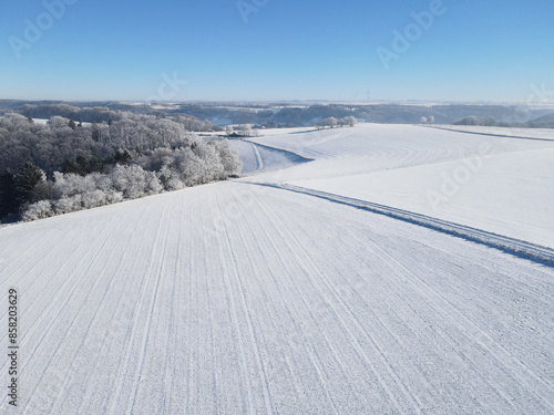 Aerial view of farm fields with snow in winter 
