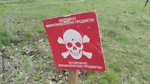 the sign Beware of Mines is installed on the minefield photo