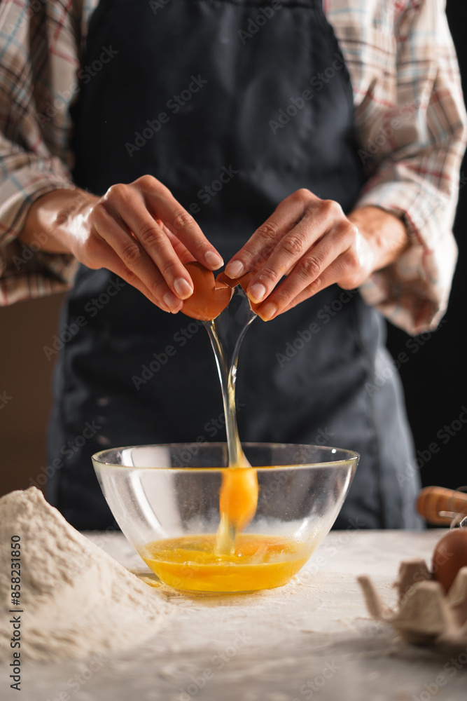 close-up of female hands without a face throws an egg into a bowl, holds the shells in her hands close-up of female hands without a face throws an egg into a bowl, holds the shells in her hands