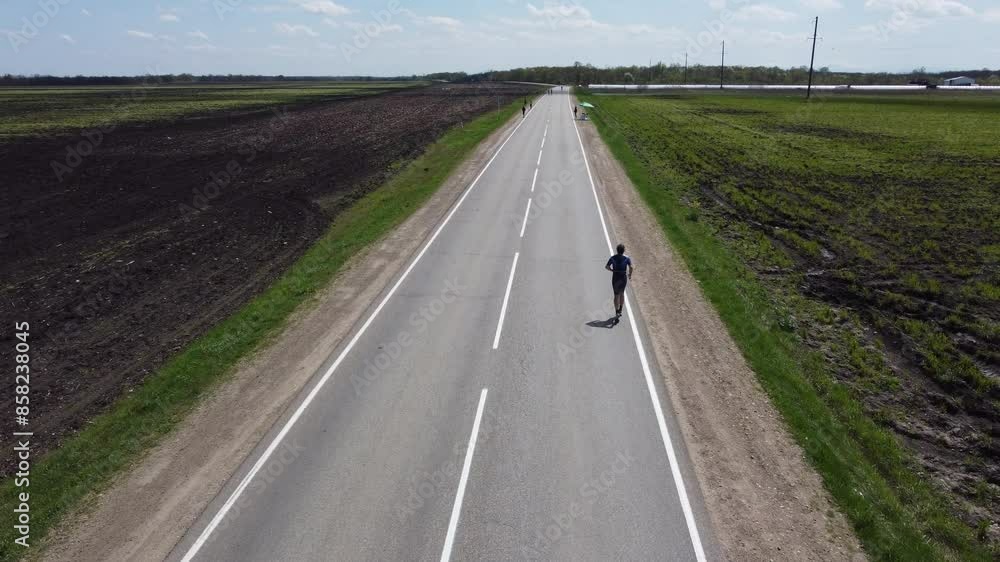 A running competition. Athletes are running along the road. Aerial view A running competition. Athletes are running along the road. Aerial view