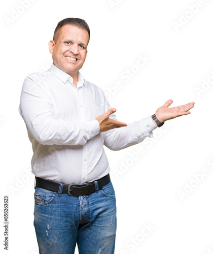 Middle age arab elegant man over isolated background Inviting to enter smiling natural with open hand