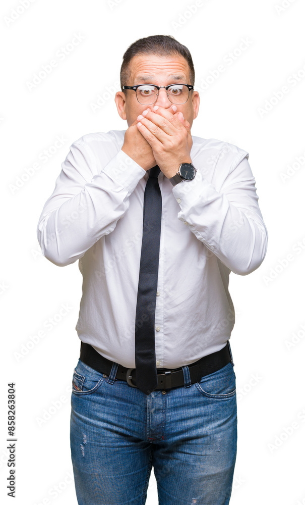 Middle age bussines arab man wearing glasses over isolated background shocked covering mouth with hands for mistake. Secret concept. Middle age bussines arab man wearing glasses over isolated background shocked covering mouth with hands for mistake. Secret concept.