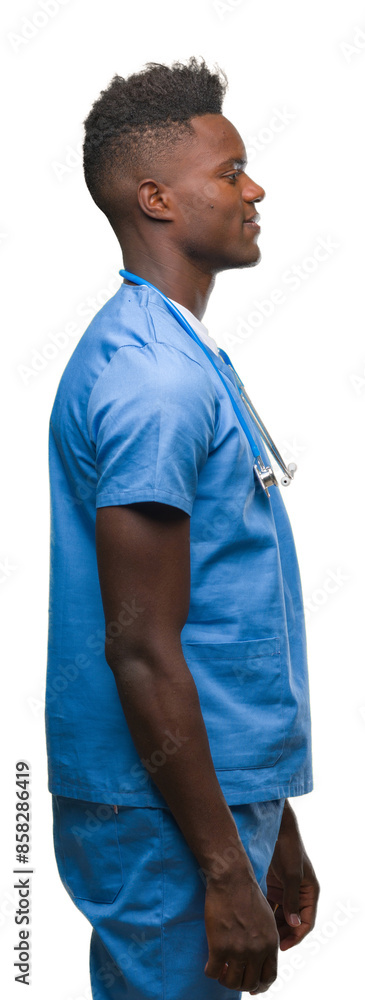 Young african american doctor man over isolated background wearing surgeon uniform looking to side, relax profile pose with natural face with confident smile. Young african american doctor man over isolated background wearing surgeon uniform looking to side, relax profile pose with natural face with confident smile.