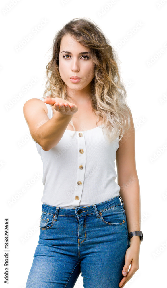 Young beautiful blonde woman over isolated background looking at the camera blowing a kiss with hand on air being lovely and sexy. Love expression. Young beautiful blonde woman over isolated background looking at the camera blowing a kiss with hand on air being lovely and sexy. Love expression.