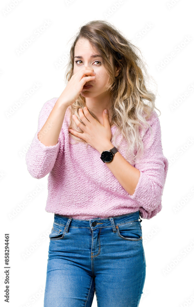 Beautiful young blonde woman over isolated background smelling something stinky and disgusting, intolerable smell, holding breath with fingers on nose. Bad smells concept.