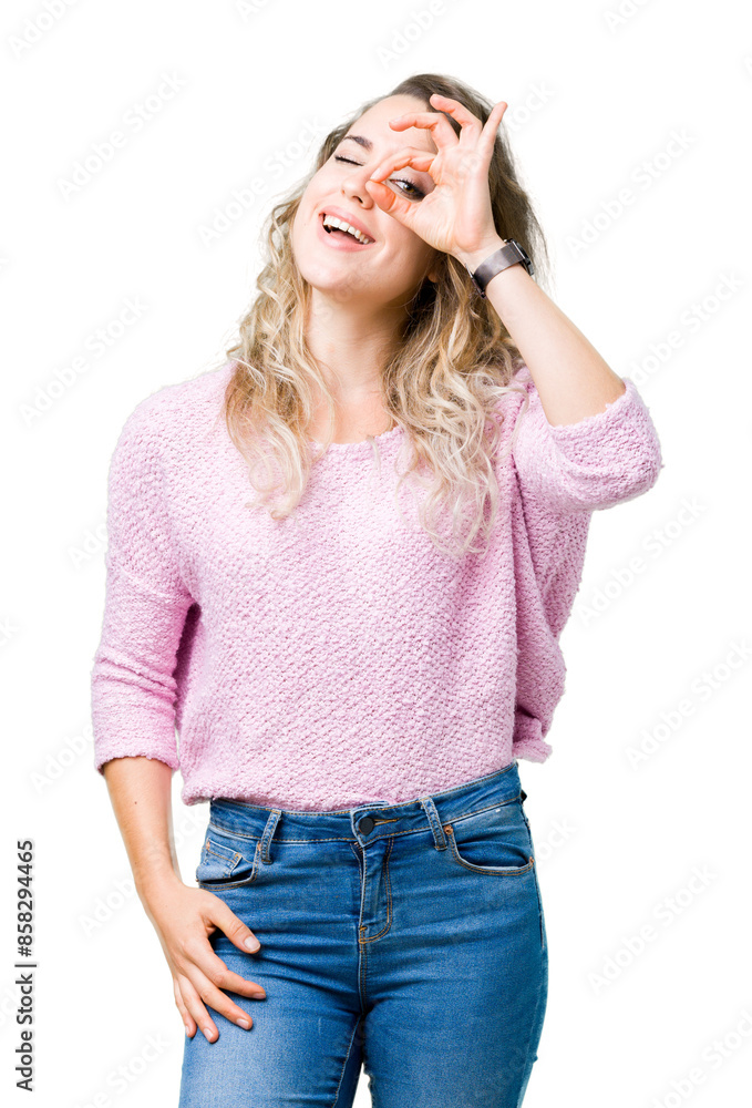 Beautiful young blonde woman over isolated background doing ok gesture with hand smiling, eye looking through fingers with happy face. Beautiful young blonde woman over isolated background doing ok gesture with hand smiling, eye looking through fingers with happy face.