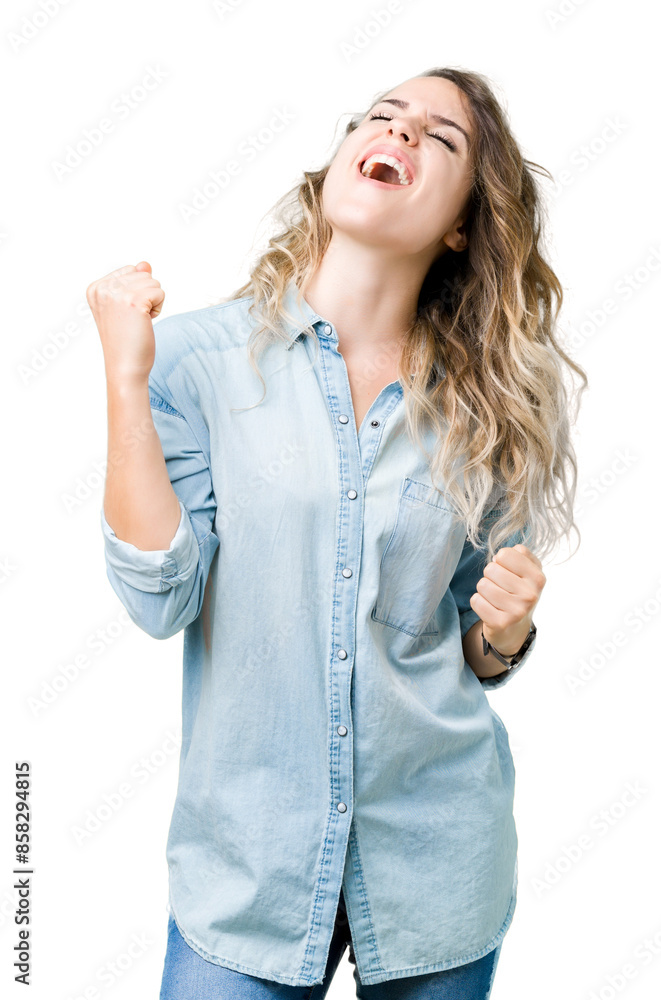 Beautiful young blonde woman over isolated background very happy and excited doing winner gesture with arms raised, smiling and screaming for success. Celebration concept. Beautiful young blonde woman over isolated background very happy and excited doing winner gesture with arms raised, smiling and screaming for success. Celebration concept.