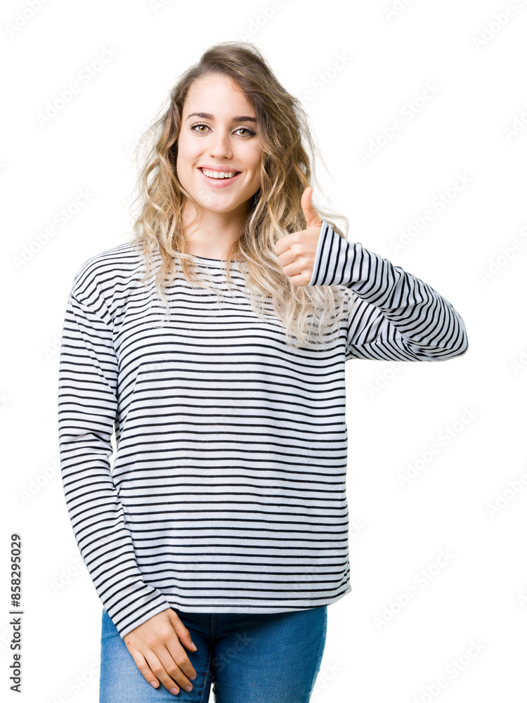 Beautiful young blonde woman wearing stripes sweater over isolated background doing happy thumbs up gesture with hand. Approving expression looking at the camera showing success. Beautiful young blonde woman wearing stripes sweater over isolated background doing happy thumbs up gesture with hand. Approving expression looking at the camera showing success.
