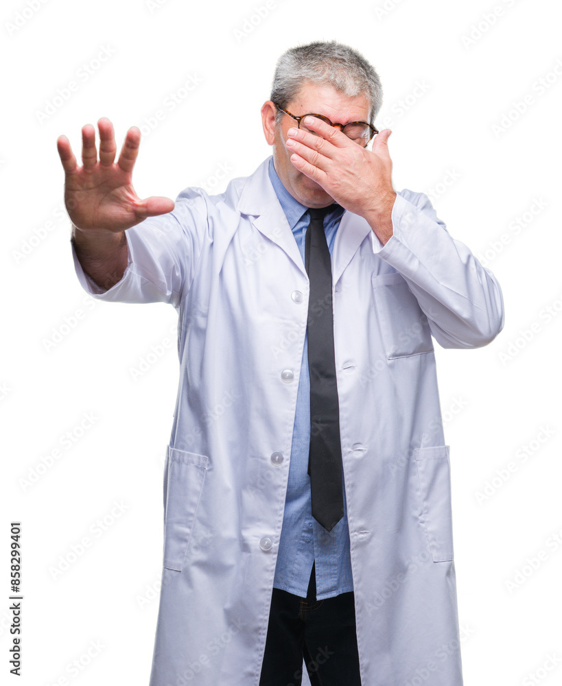 Handsome senior doctor, scientist professional man wearing white coat over isolated background covering eyes with hands and doing stop gesture with sad and fear expression. Handsome senior doctor, scientist professional man wearing white coat over isolated background covering eyes with hands and doing stop gesture with sad and fear expression.
