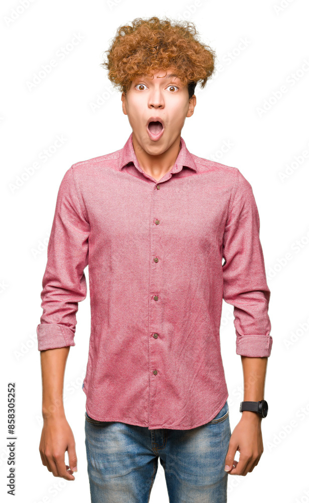 Young handsome business man with afro hair afraid and shocked with surprise expression, fear and excited face. Young handsome business man with afro hair afraid and shocked with surprise expression, fear and excited face.