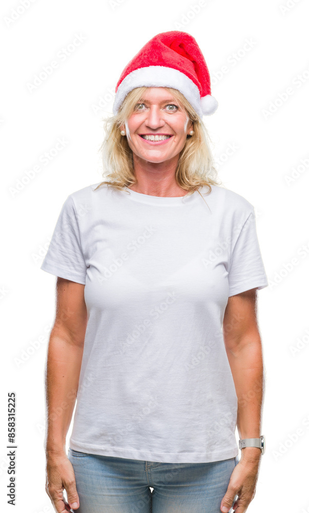 Middle age blonde woman wearing christmas hat over isolated background with a happy and cool smile on face. Lucky person. Middle age blonde woman wearing christmas hat over isolated background with a happy and cool smile on face. Lucky person.
