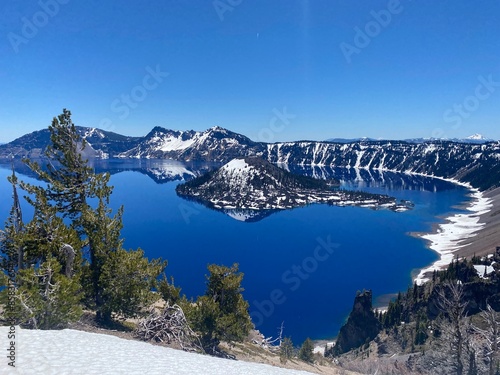 Crater Lake in the winter with snow covered mountains in the background photo