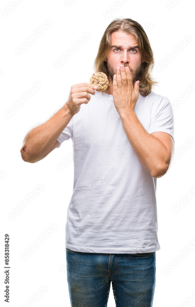 Young handsome man with long hair eating chocolate cooky over isolated background cover mouth with hand shocked with shame for mistake, expression of fear, scared in silence, secret concept Young handsome man with long hair eating chocolate cooky over isolated background cover mouth with hand shocked with shame for mistake, expression of fear, scared in silence, secret concept