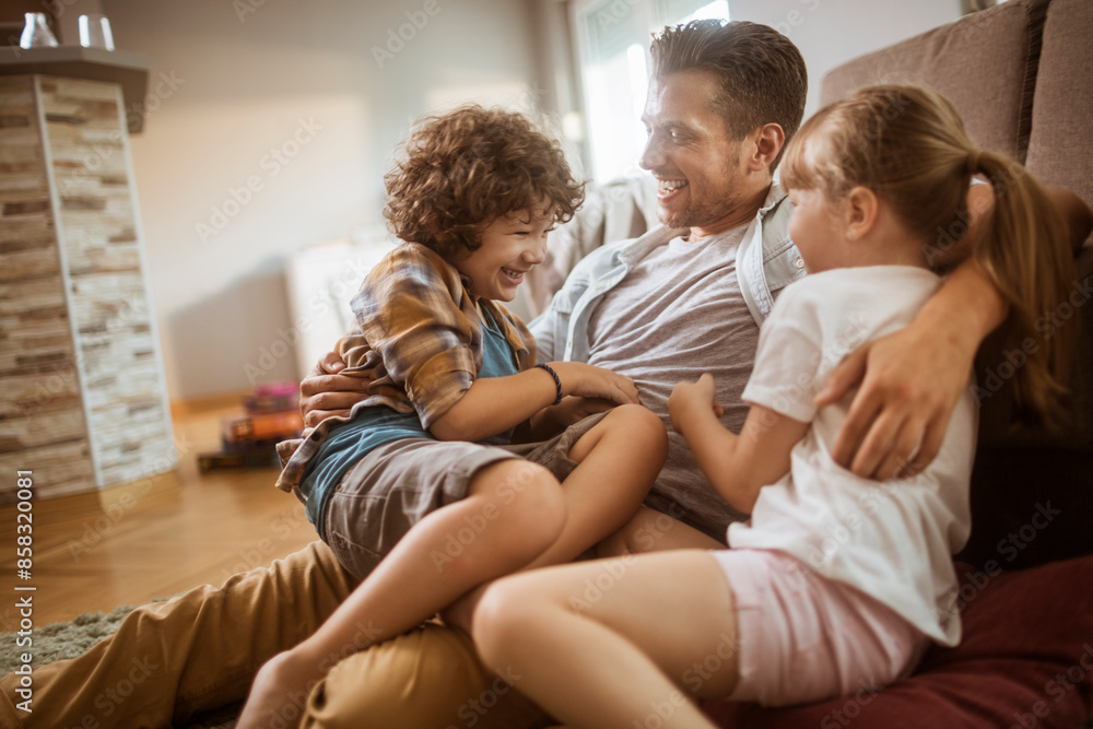 Happy father playing with son and daughter at home Happy father playing with son and daughter at home