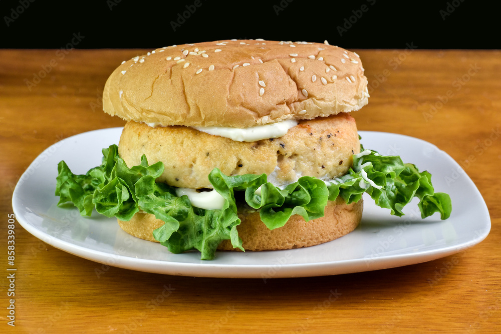 salmon burger top with tarter sauce and parsley salmon burger top with tarter sauce and parsley