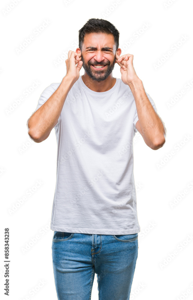 Adult hispanic man over isolated background covering ears with fingers with annoyed expression for the noise of loud music. Deaf concept. Adult hispanic man over isolated background covering ears with fingers with annoyed expression for the noise of loud music. Deaf concept.