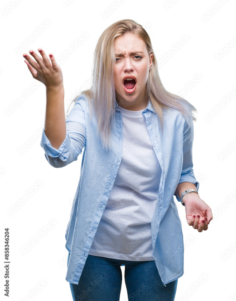Young blonde woman over isolated background angry and mad raising fist frustrated and furious while shouting with anger. Rage and aggressive concept. Young blonde woman over isolated background angry and mad raising fist frustrated and furious while shouting with anger. Rage and aggressive concept.