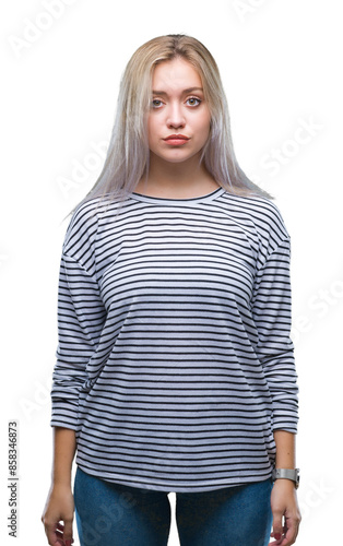 Young blonde woman over isolated background with serious expression on face. Simple and natural looking at the camera.