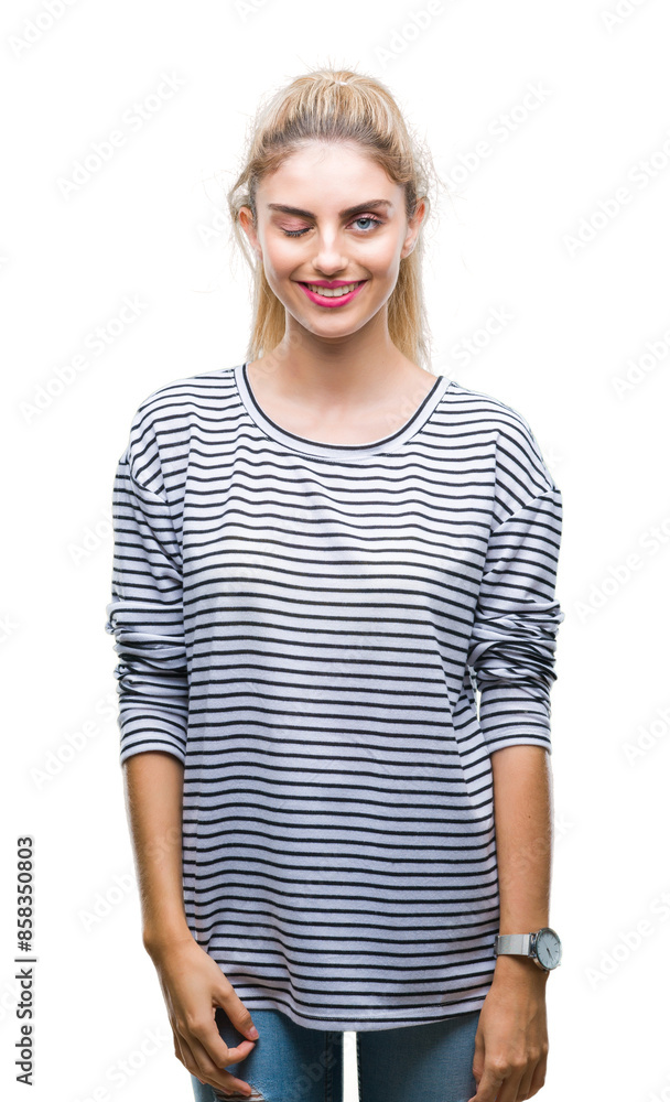 Young beautiful blonde woman wearing stripes sweater over isolated background winking looking at the camera with sexy expression, cheerful and happy face. Young beautiful blonde woman wearing stripes sweater over isolated background winking looking at the camera with sexy expression, cheerful and happy face.