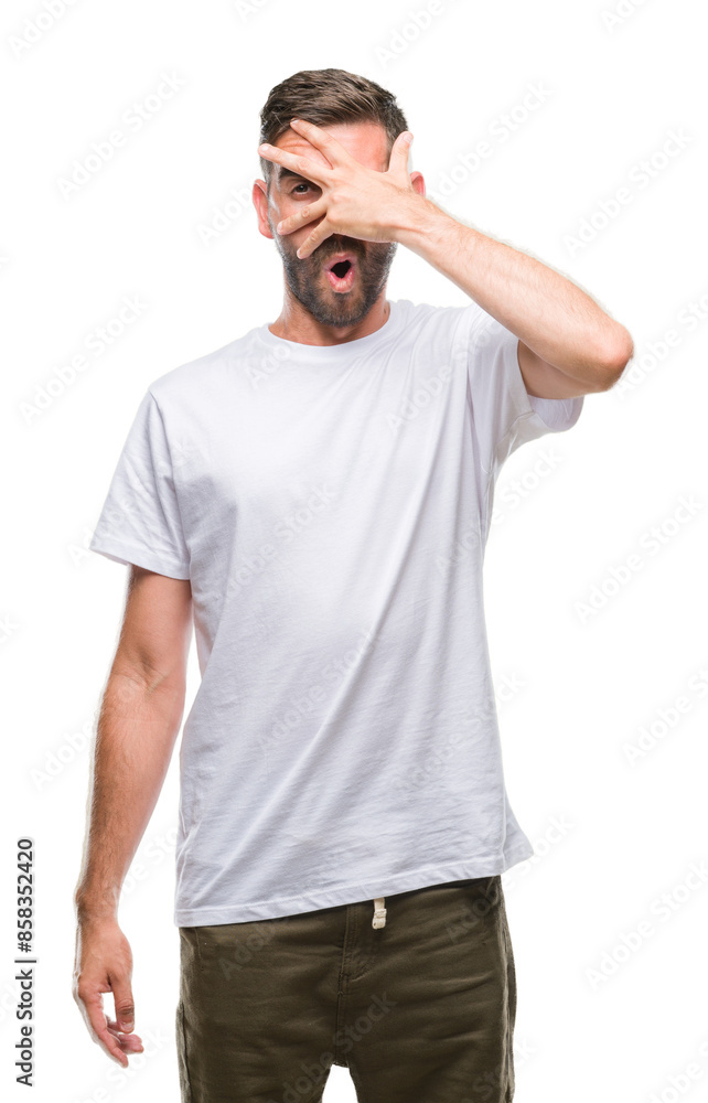 Young handsome man over isolated background peeking in shock covering face and eyes with hand, looking through fingers with embarrassed expression. Young handsome man over isolated background peeking in shock covering face and eyes with hand, looking through fingers with embarrassed expression.