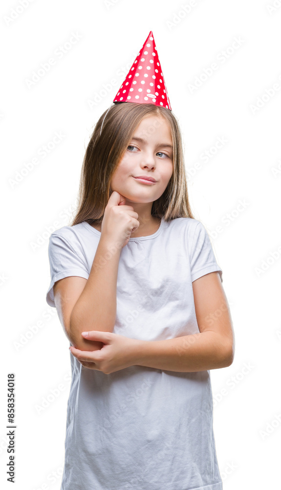 Young beautiful girl wearing birthday cap over isolated background with hand on chin thinking about question, pensive expression. Smiling with thoughtful face. Doubt concept. Young beautiful girl wearing birthday cap over isolated background with hand on chin thinking about question, pensive expression. Smiling with thoughtful face. Doubt concept.