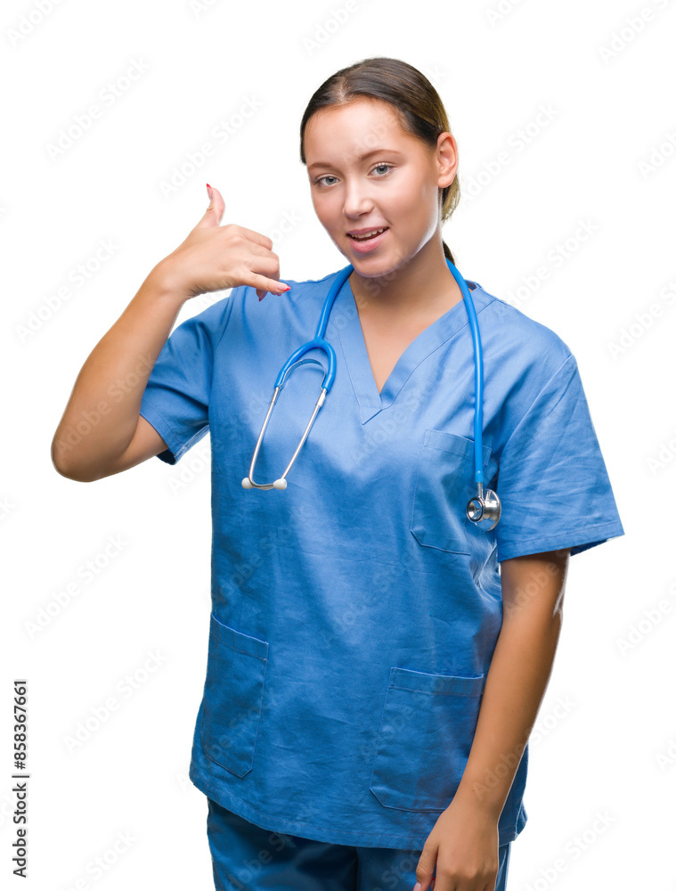 Young caucasian doctor woman wearing medical uniform over isolated background smiling doing phone gesture with hand and fingers like talking on the telephone. Communicating concepts. Young caucasian doctor woman wearing medical uniform over isolated background smiling doing phone gesture with hand and fingers like talking on the telephone. Communicating concepts.
