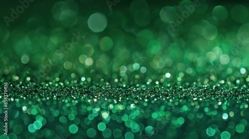 Abstract green glitter background with bokeh lights